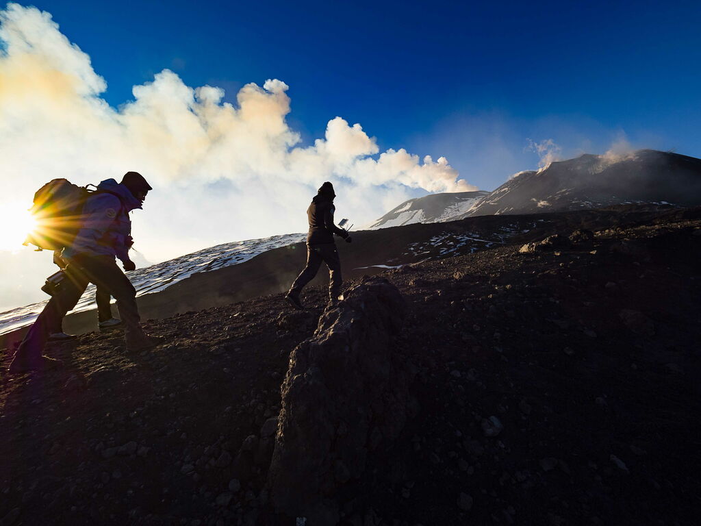 Two people hiking to the top of Mt Etna