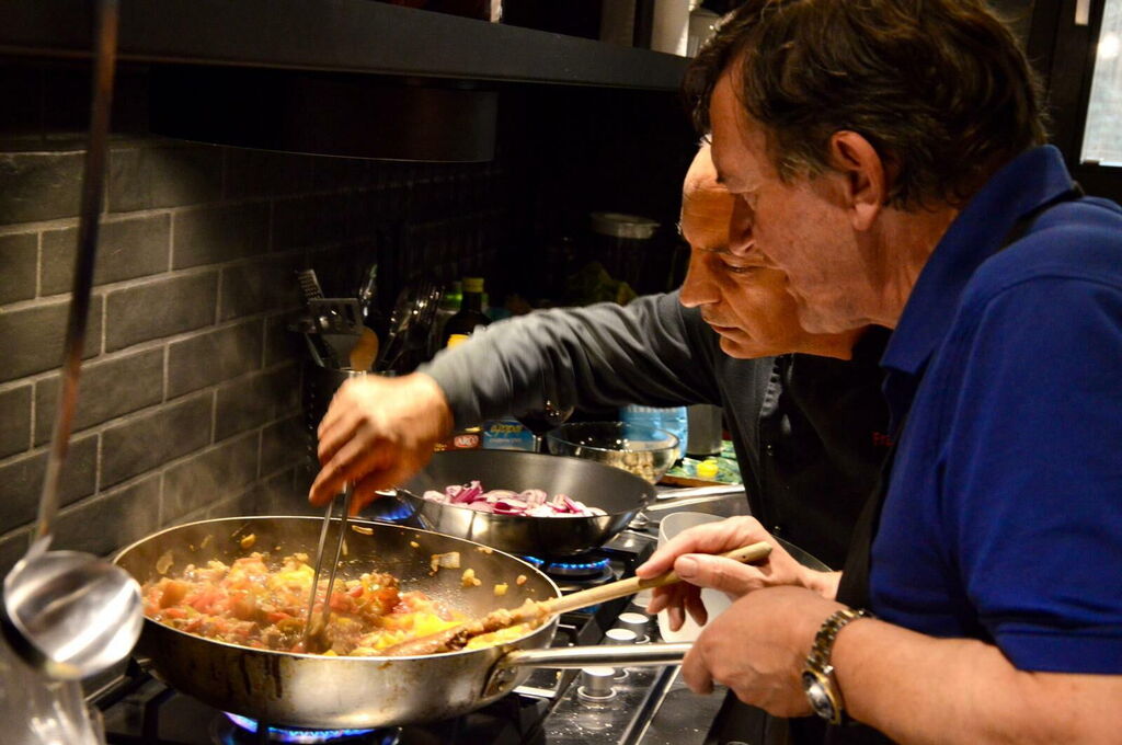 Francesco in the kitchen with a guest