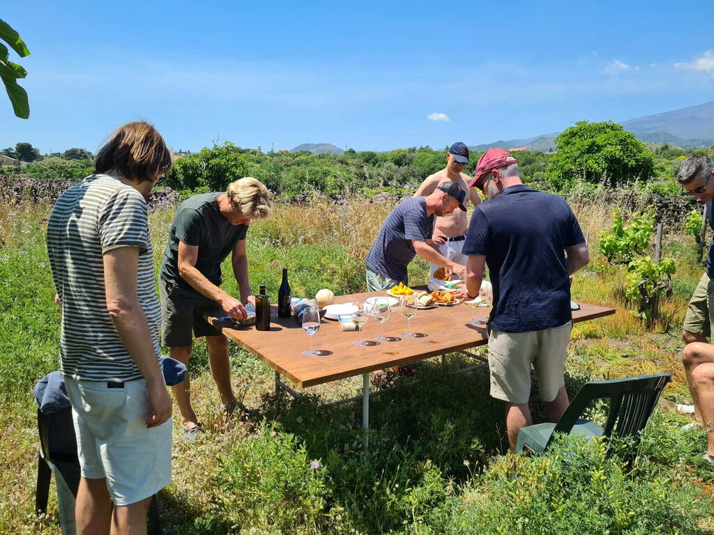 guests tasting wine in the vineyard